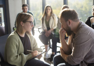 Support group discussing workplace psychosocial safety during organisational change.