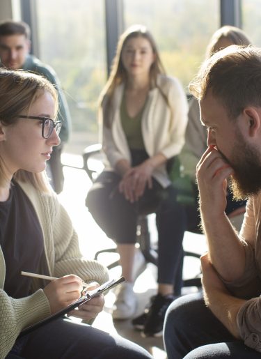 Support group discussing workplace psychosocial safety during organisational change.