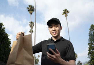Delivery man getting parcel out