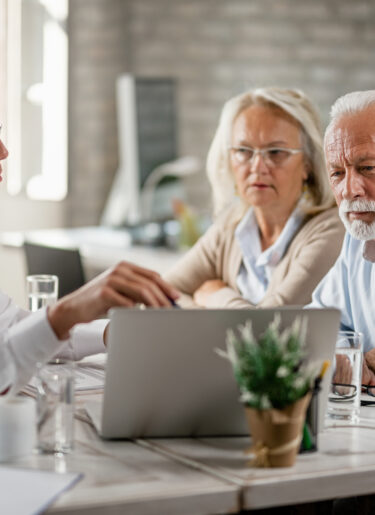 Senior couple and financial advisor in a meeting