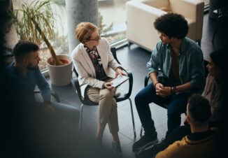 Above view of counseling during group therapy at mental health center.