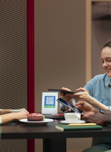 People consulting a menu on their phone