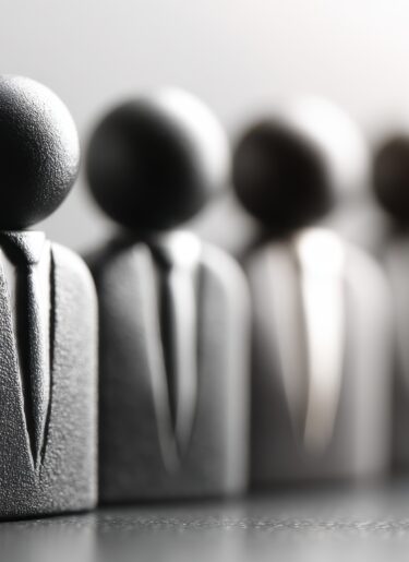 Business figurines in suits representing a flexible workforce.