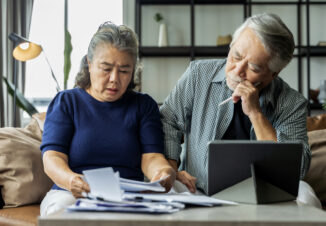Serious asian senior old couple discussing