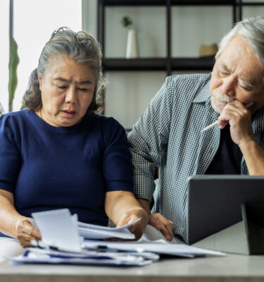 Serious asian senior old couple discussing