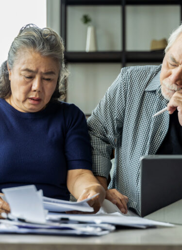 Serious asian senior old couple discussing