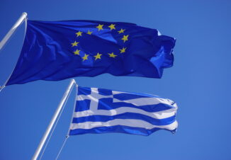 A Greek and European Union (EU) flags flying side by side