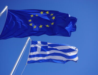 A Greek and European Union (EU) flags flying side by side