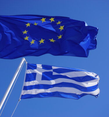 A Greek and European Union (EU) flags flying side by side