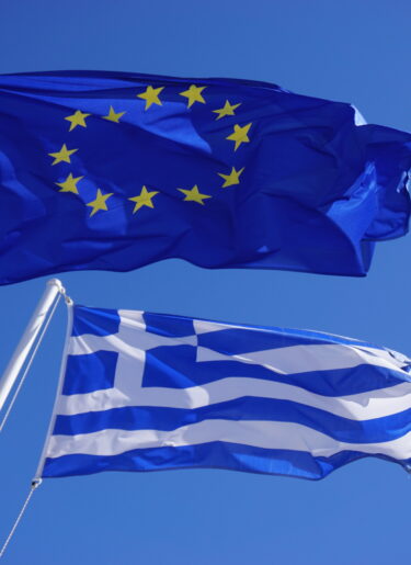 A Greek and European Union (EU) flags flying side by side