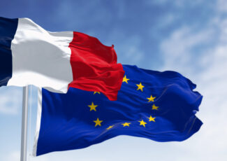 The flags of France and the European Union waving together on a clear day