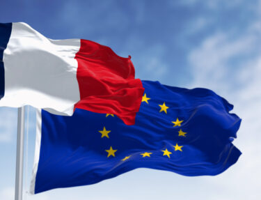 The flags of France and the European Union waving together on a clear day
