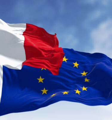 The flags of France and the European Union waving together on a clear day