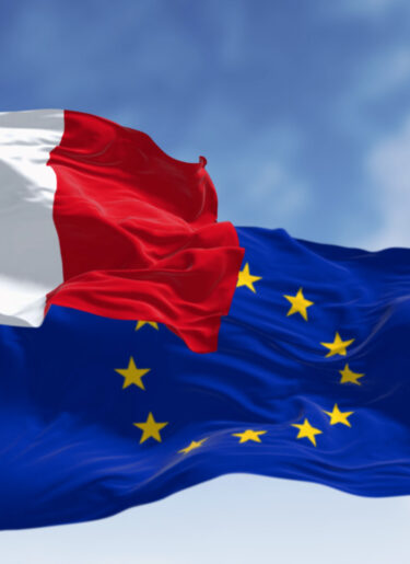 The flags of France and the European Union waving together on a clear day