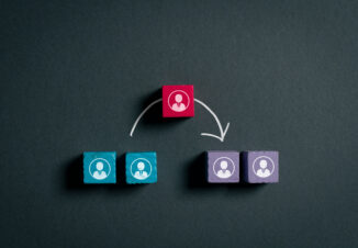 Wooden employee icon moving between two teams, representing workforce mobility, reassignment, talent transfer, organizational change and internal career transition.